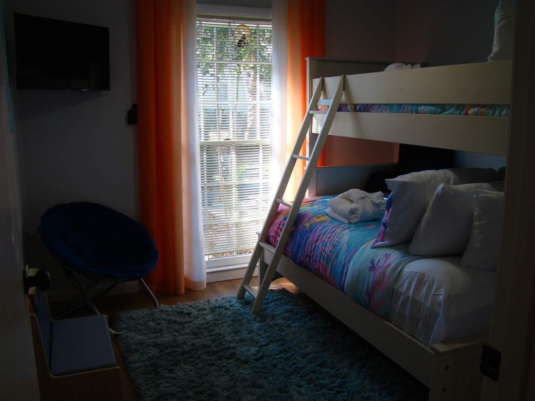 Bunk room with twin-over-full bunk bed, TV and shag rug